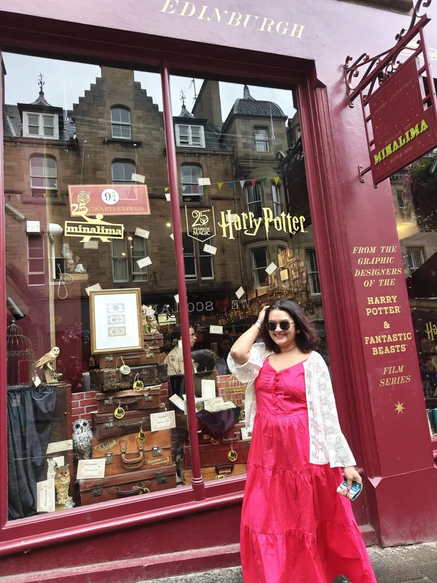 Bhagyashri outside a red shopfront in Edinburgh