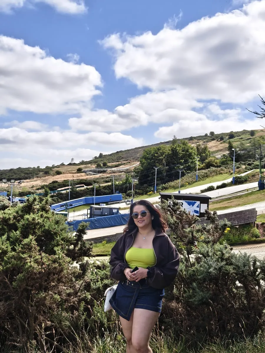 Bhagyashri on a hillside under a blue sky